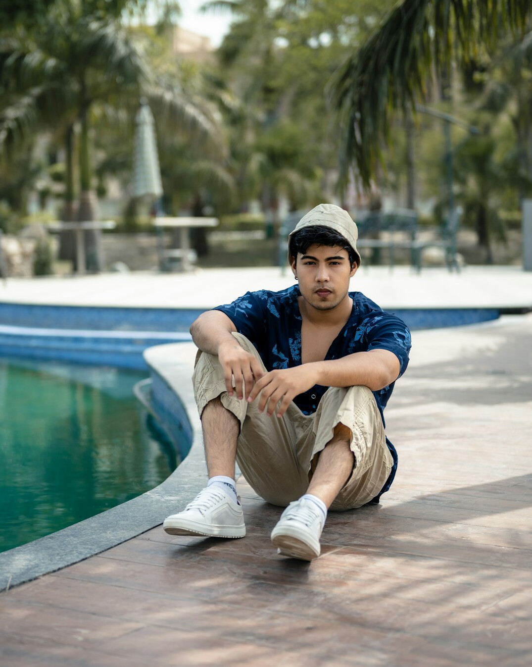 actor relaxing by pool